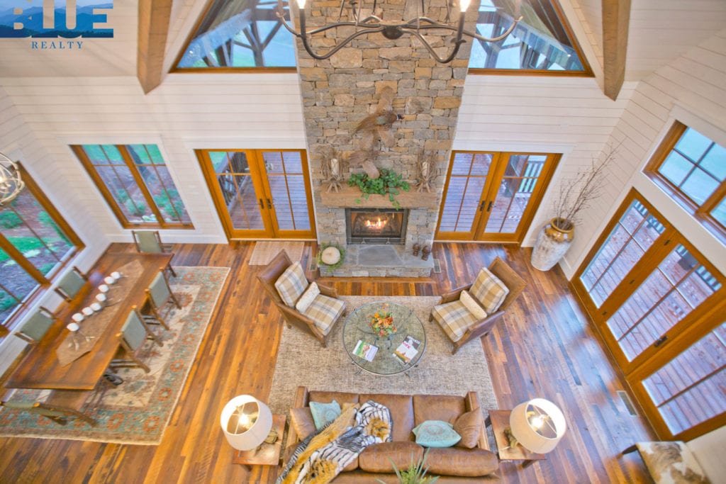 Floor to ceiling windows and stone fireplace