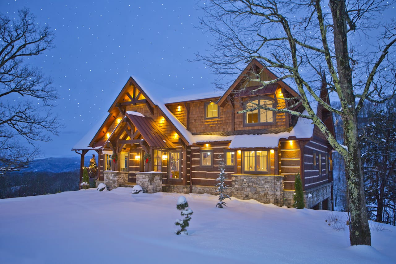 mountain home covered in snow